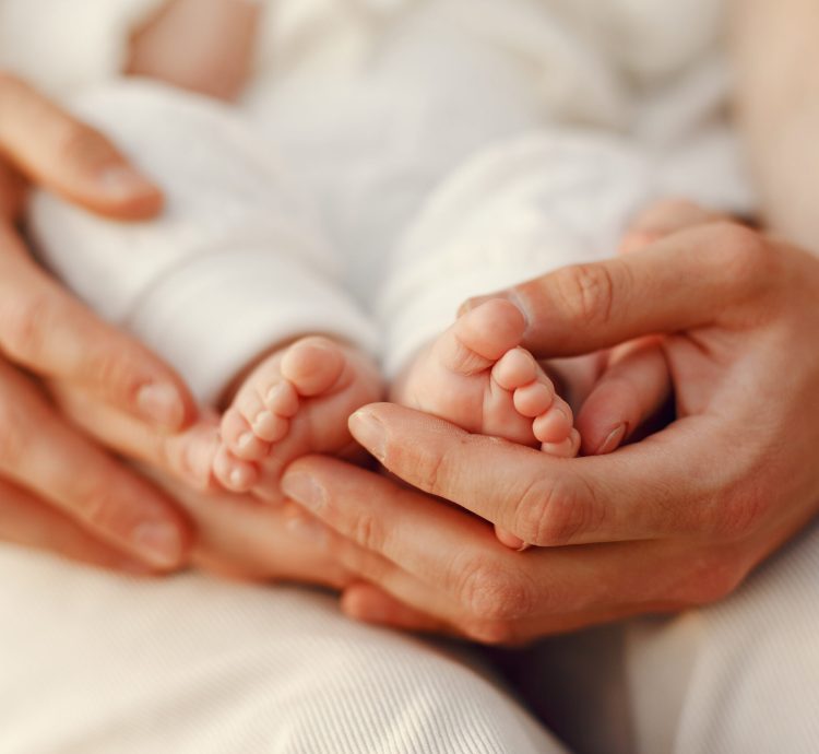 Parents with daughter. Family in a park. Newborn girl.